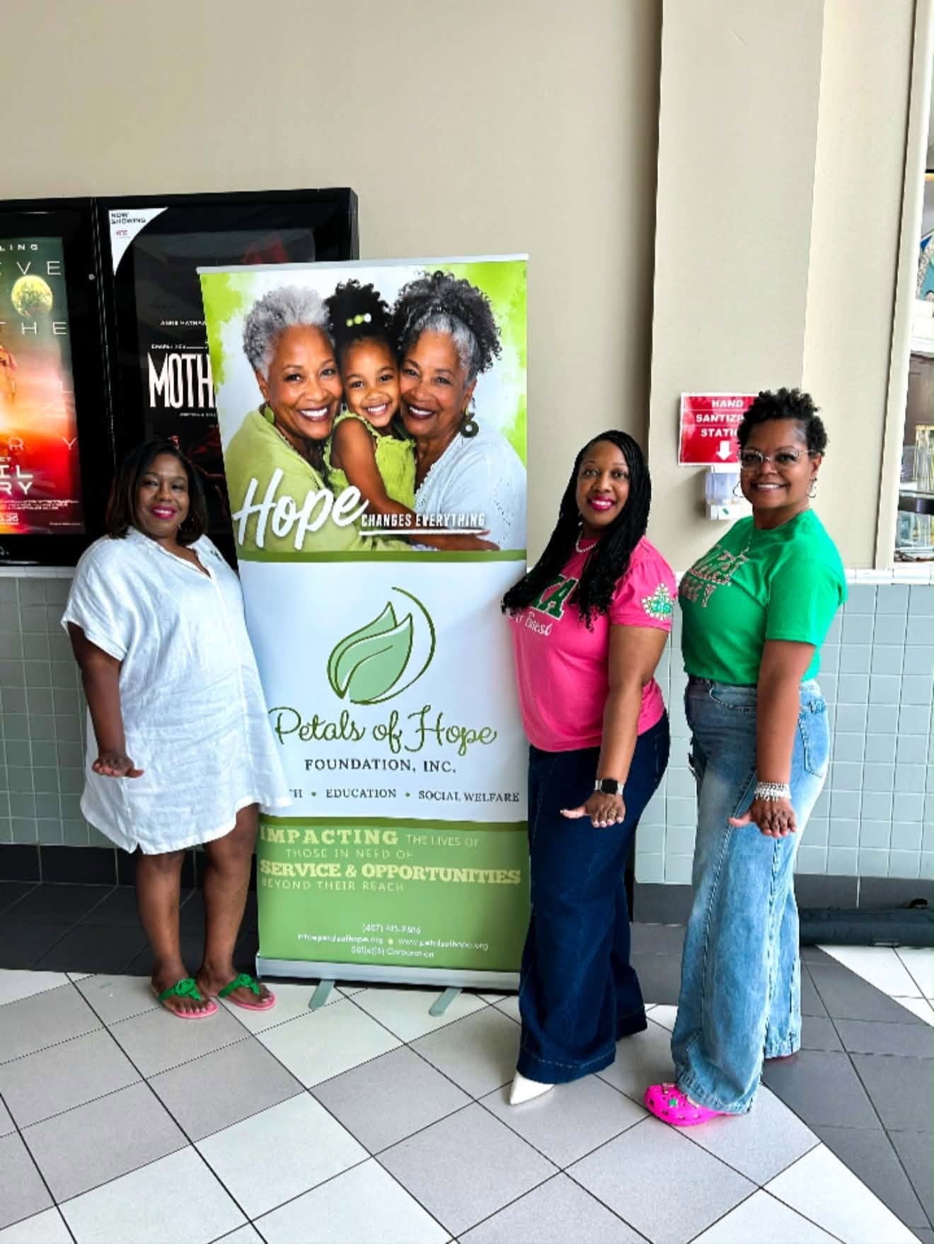 Petals of Hope Foundation members beside the organization banner at the Michael movie event